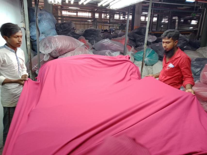 Handling bulk pink fabric on the floor
